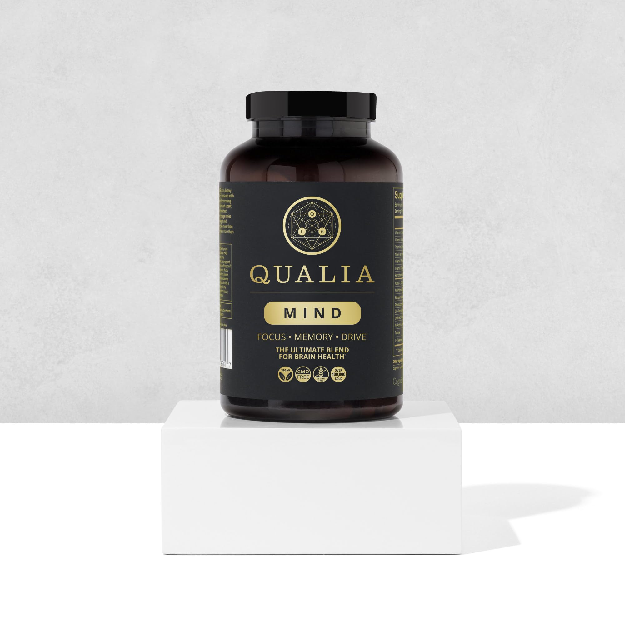 Qualia Mind capsules arranged neatly for daily routines.