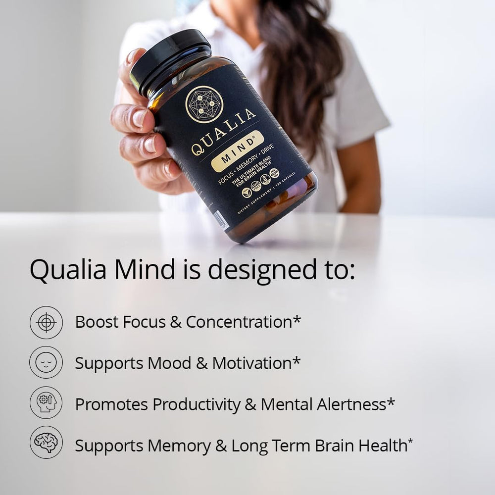 Qualia Mind capsules lined up on desk for quick mental clarity.