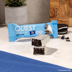 Desk-side Quest Cookies & Cream Crispy Bar ready for a quick treat.