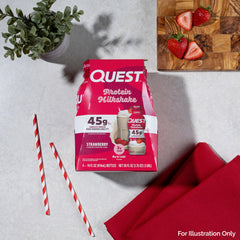 Quest Strawberry Protein Shake glass with straw beside a gym bag.