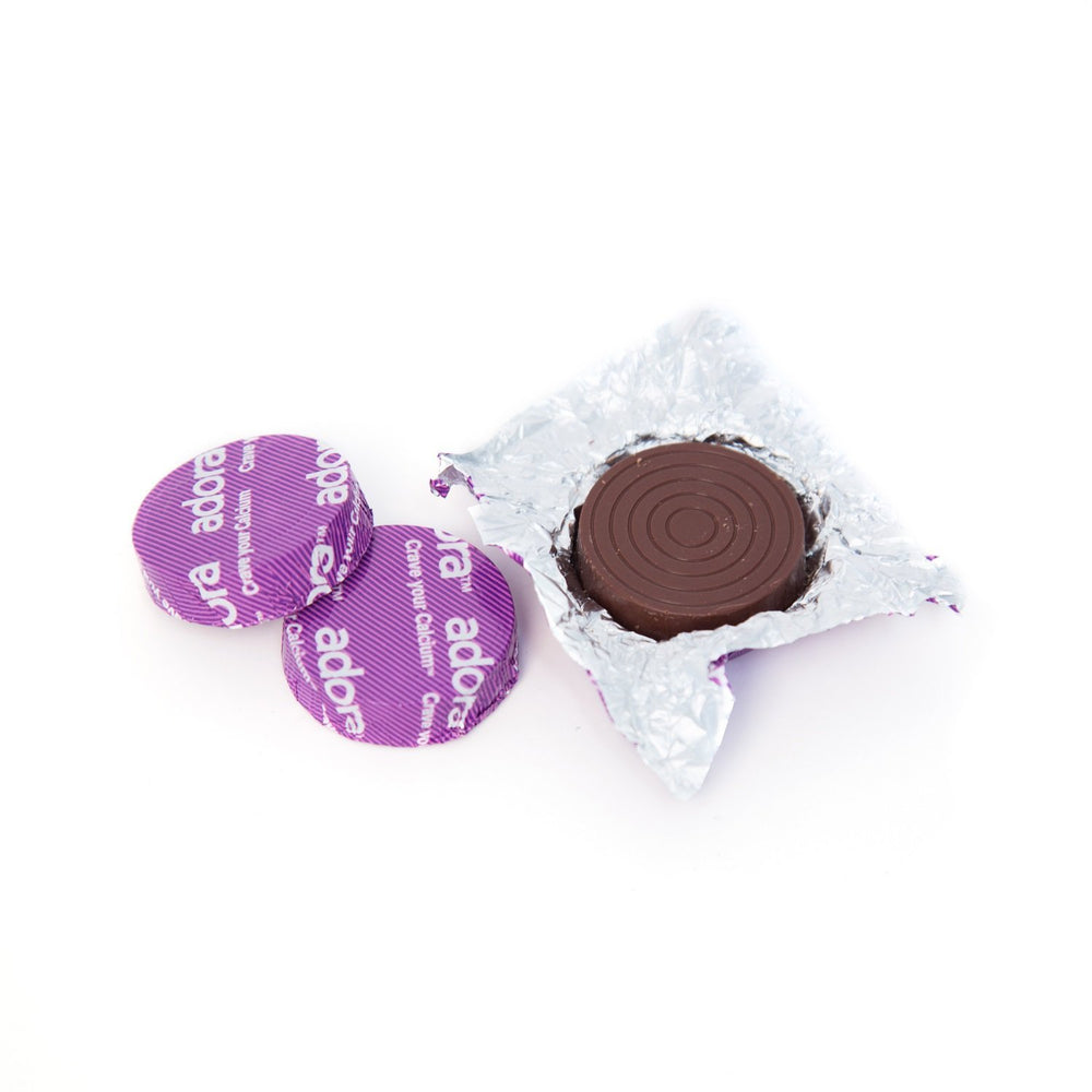Quilom Adora Calcium Dark Chocolate tablet closeup, tasty supplement option.