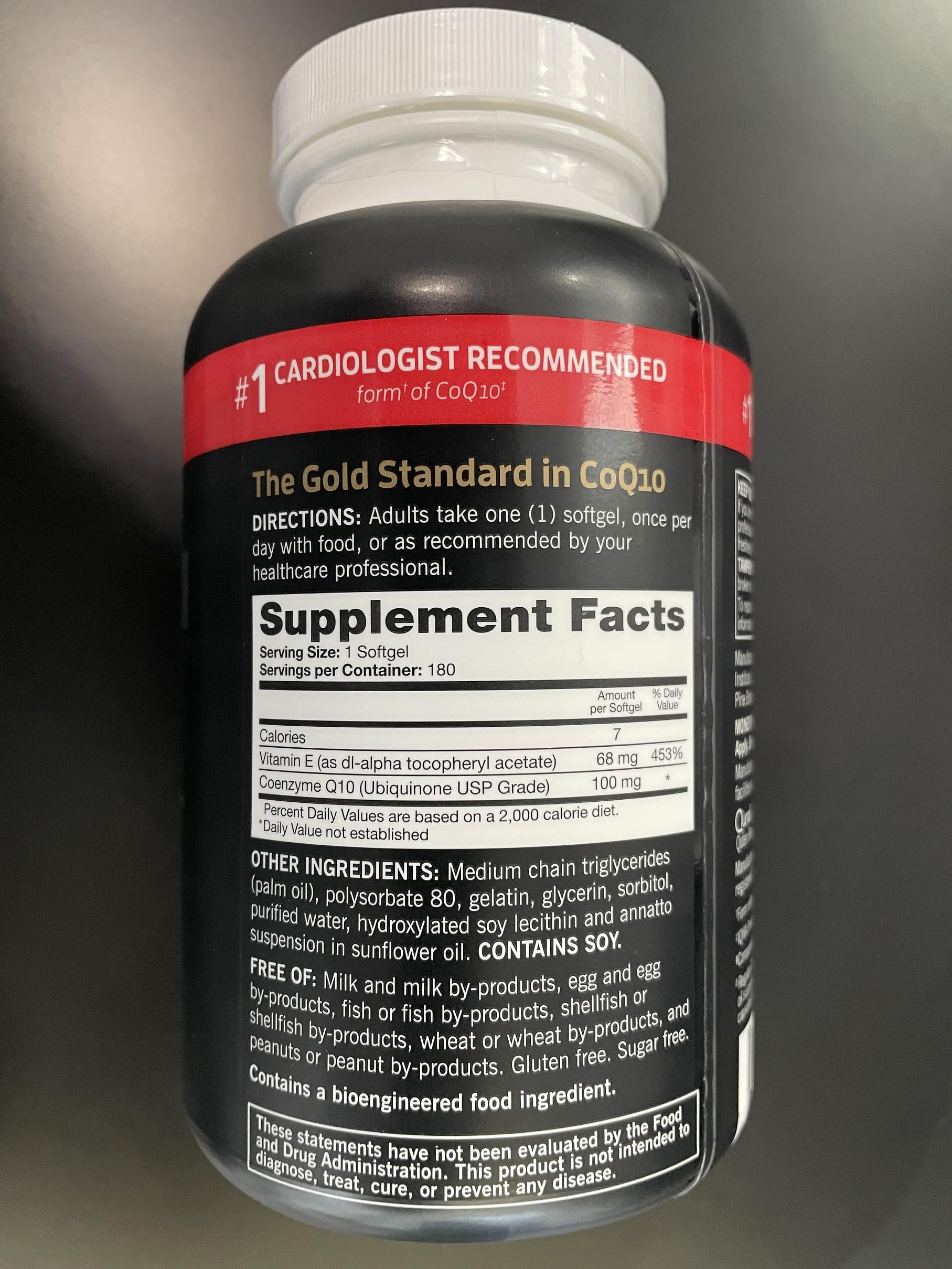 Qunol Ultra CoQ10 softgels being poured from the bottle.