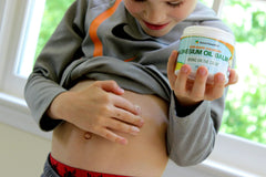 Ingredients panel of Raise Them Well calming balm featuring magnesium and skin-friendly oils