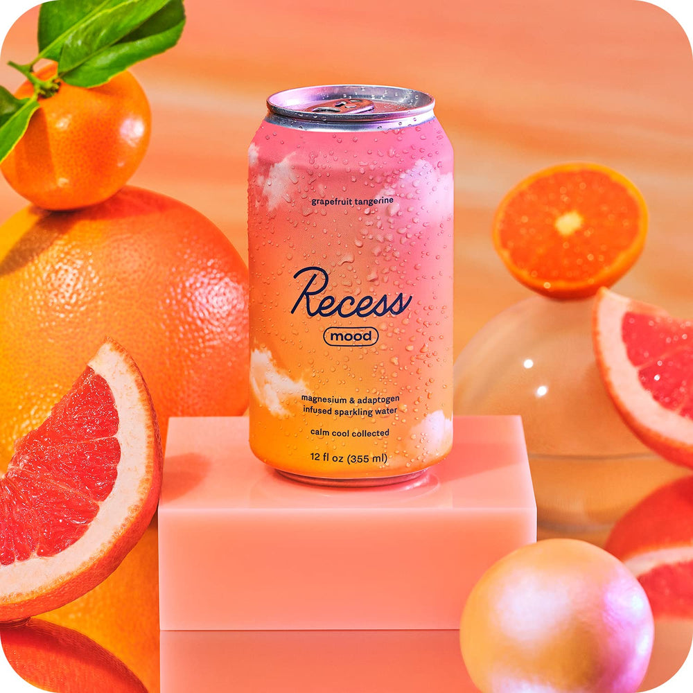 Recess Mood drink poured into a glass with bubbles and citrus aroma.