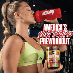 Total War Reloaded bottle on gym shelf with workout gear nearby.
