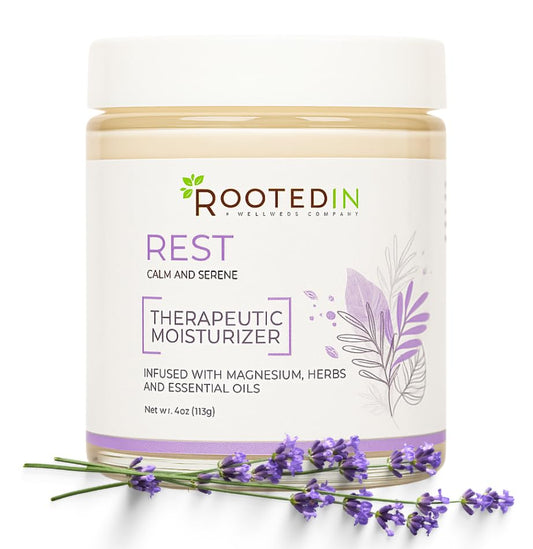 Rooted In Rest magnesium lotion bottle ready for night-time use.