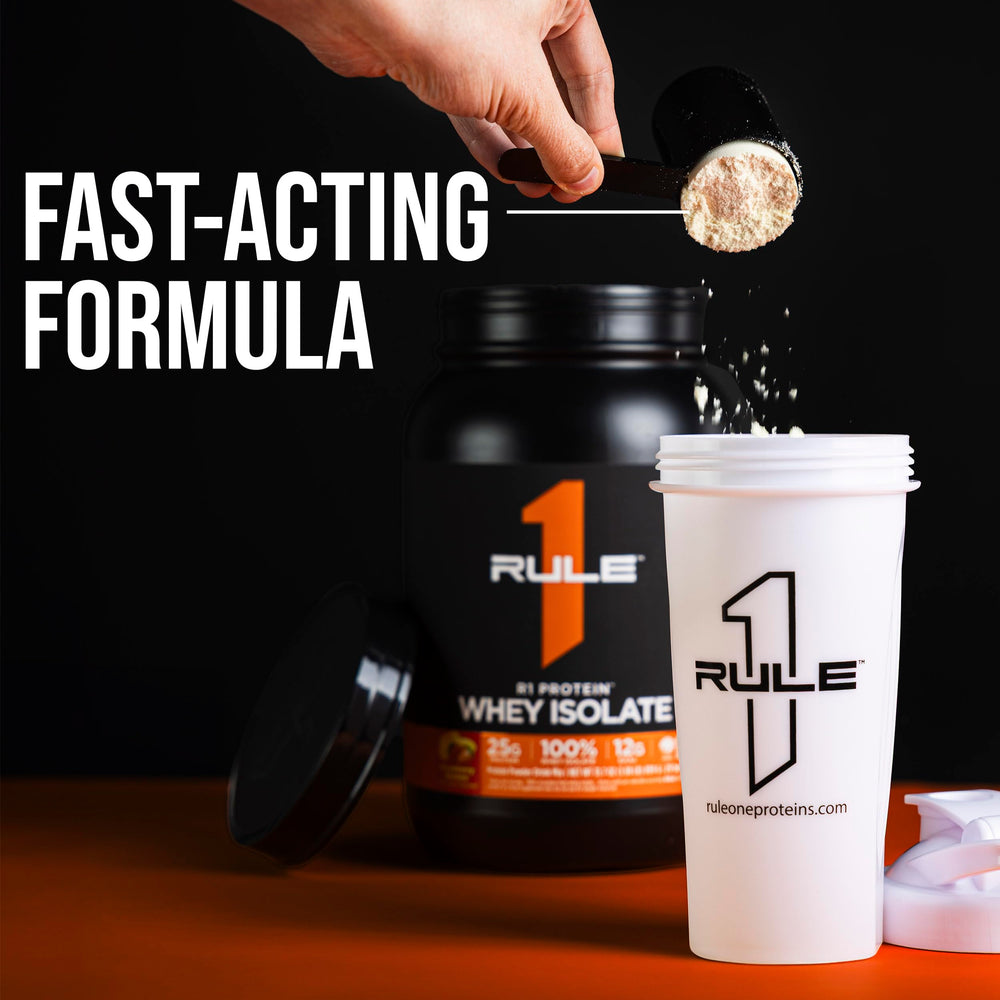Rule 1 R1 Protein Whey Isolate post-workout setup with glass and powder.