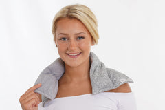 SacksyThyme microwaveable heating pad wrapped around neck and shoulders for moist heat relief.