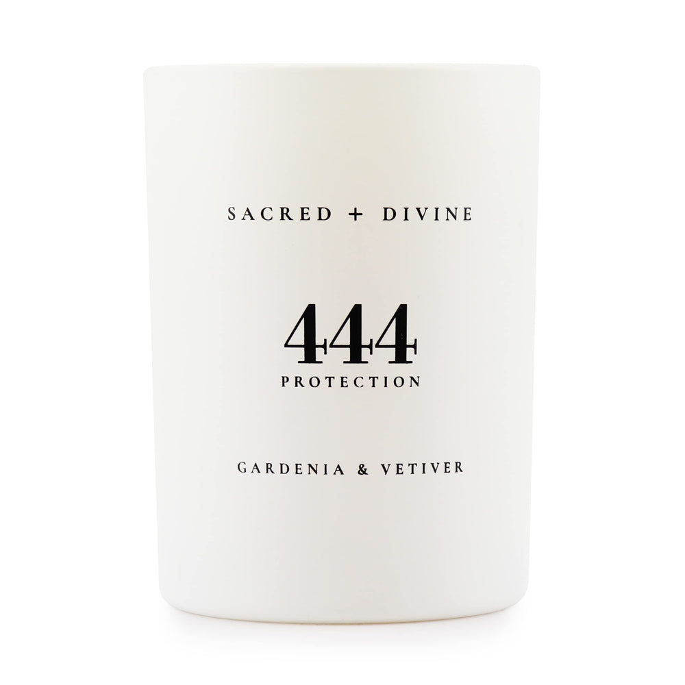 Sacred Divine 444 candle with gardenia and vetiver in a white jar enhances mood.