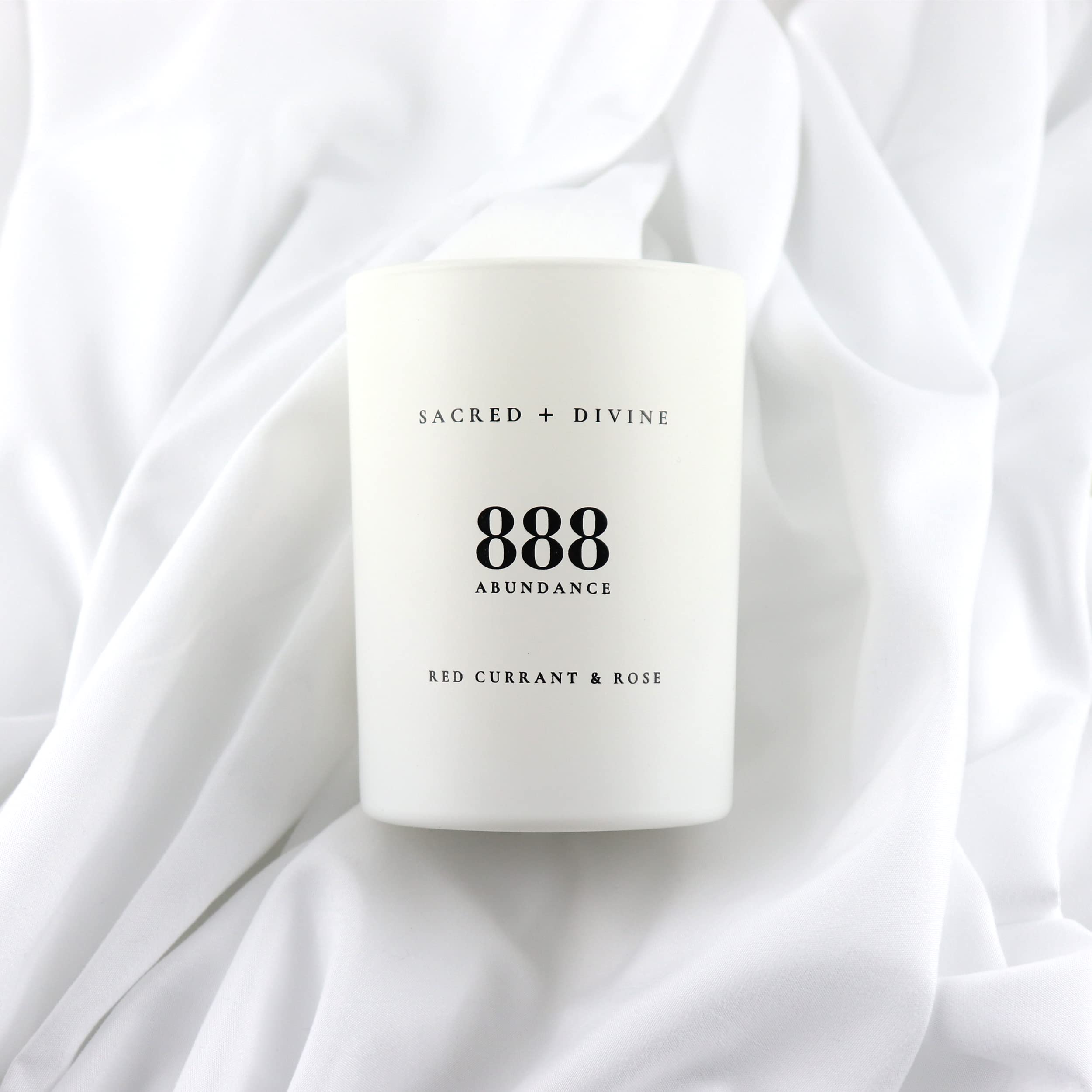 Sacred + Divine 888 abundance candle gift box packaging ready for gifting.