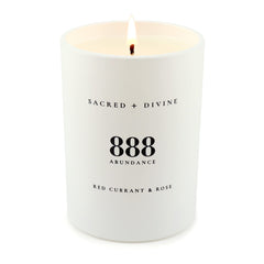 Sacred + Divine 888 abundance candle jar surface showing minimalist design.