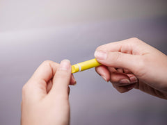 Lightweight Safeticet lancet emphasizes disposability and convenience for home testing.