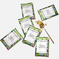 SAKARA Protein + Greens ingredients spoon with pea, hemp, and greens visible.