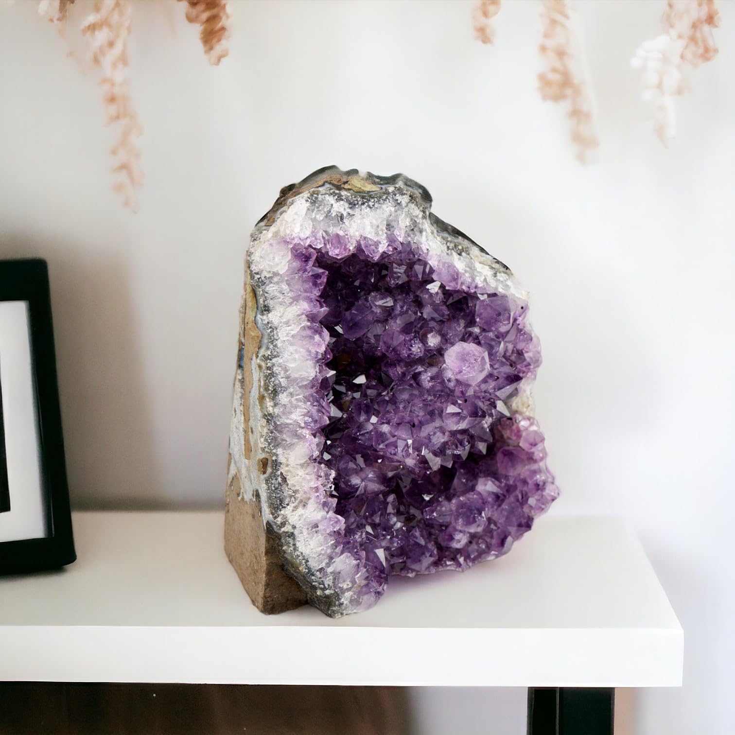 SAMSARI amethyst geode showcasing varied shapes and colors as art.