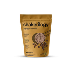 Shakeology Cafe Latte tub label highlights gluten-free plant-based protein and vitamins.