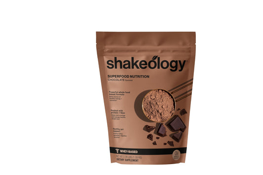 Shakeology chocolate whey protein bottle shows gluten-free formula for lean muscle support