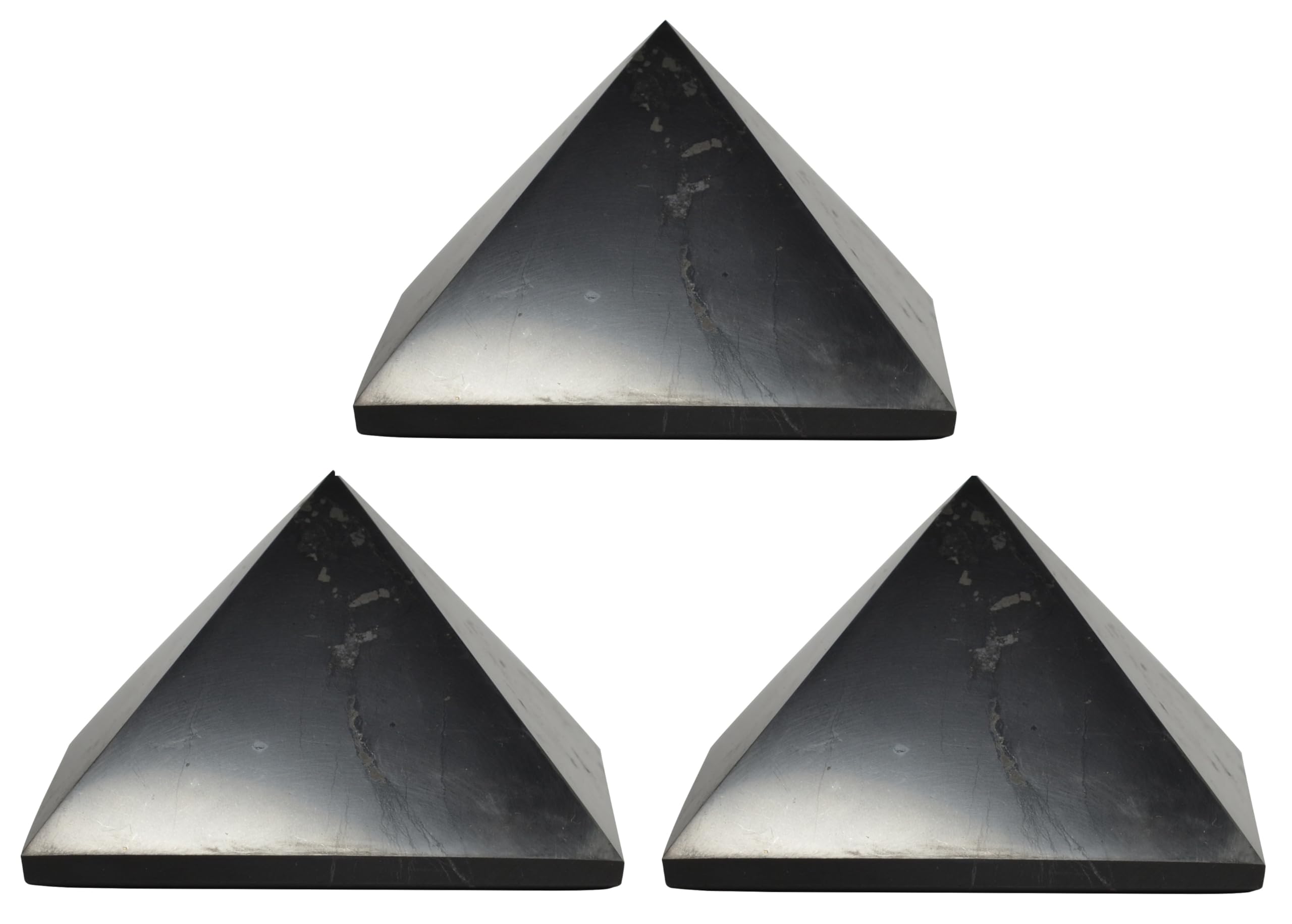 Shungite World 80mm pyramid in front view beside electronics for energy balance.
