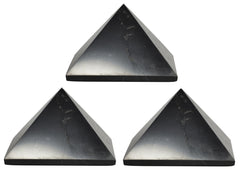 Shungite World 80mm pyramid in front view beside electronics for energy balance.