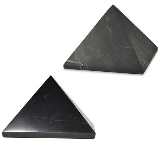 Shungite World two-pcs pyramids polished and unpolished 110 mm on a sleek desk for focus