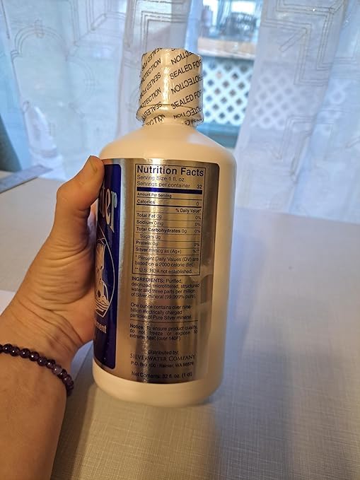 Wayne Rowland Silver Water bottle being poured for easy daily use.