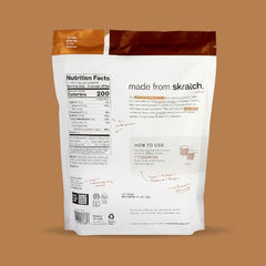 Skratch Labs Recovery Chocolate glass angled highlights creamy texture and balanced carbs.