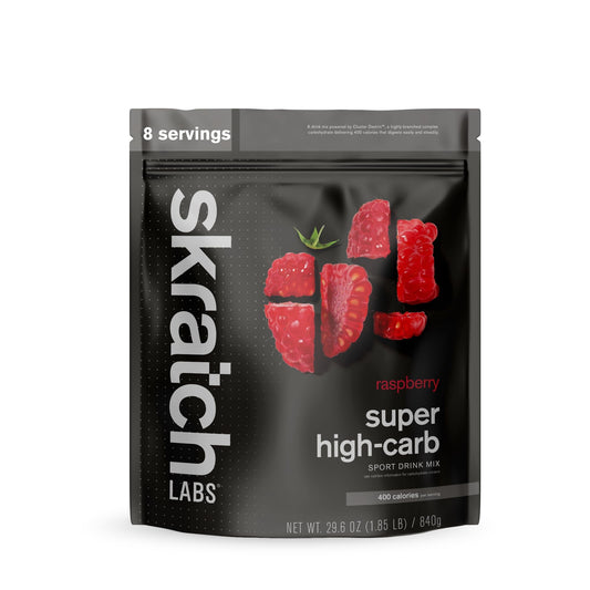 Skratch Labs Super High-Carb Hydration Raspberry bottle pour for steady endurance energy.