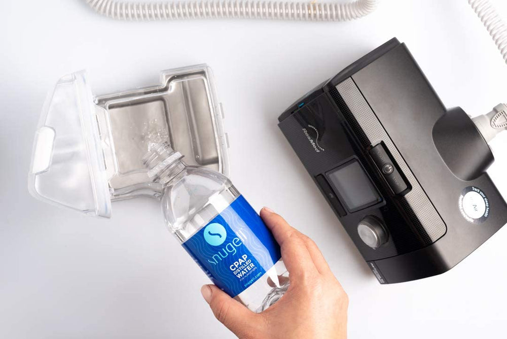 Snugell distilled water on a desk setup, highlighting multi-use versatility.