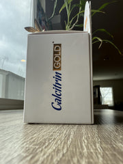Soy Sano Calcitrin Gold bottle on wood conveying natural wellness.