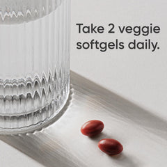 Close-up of plant-based softgel capsules ready for swallowing.