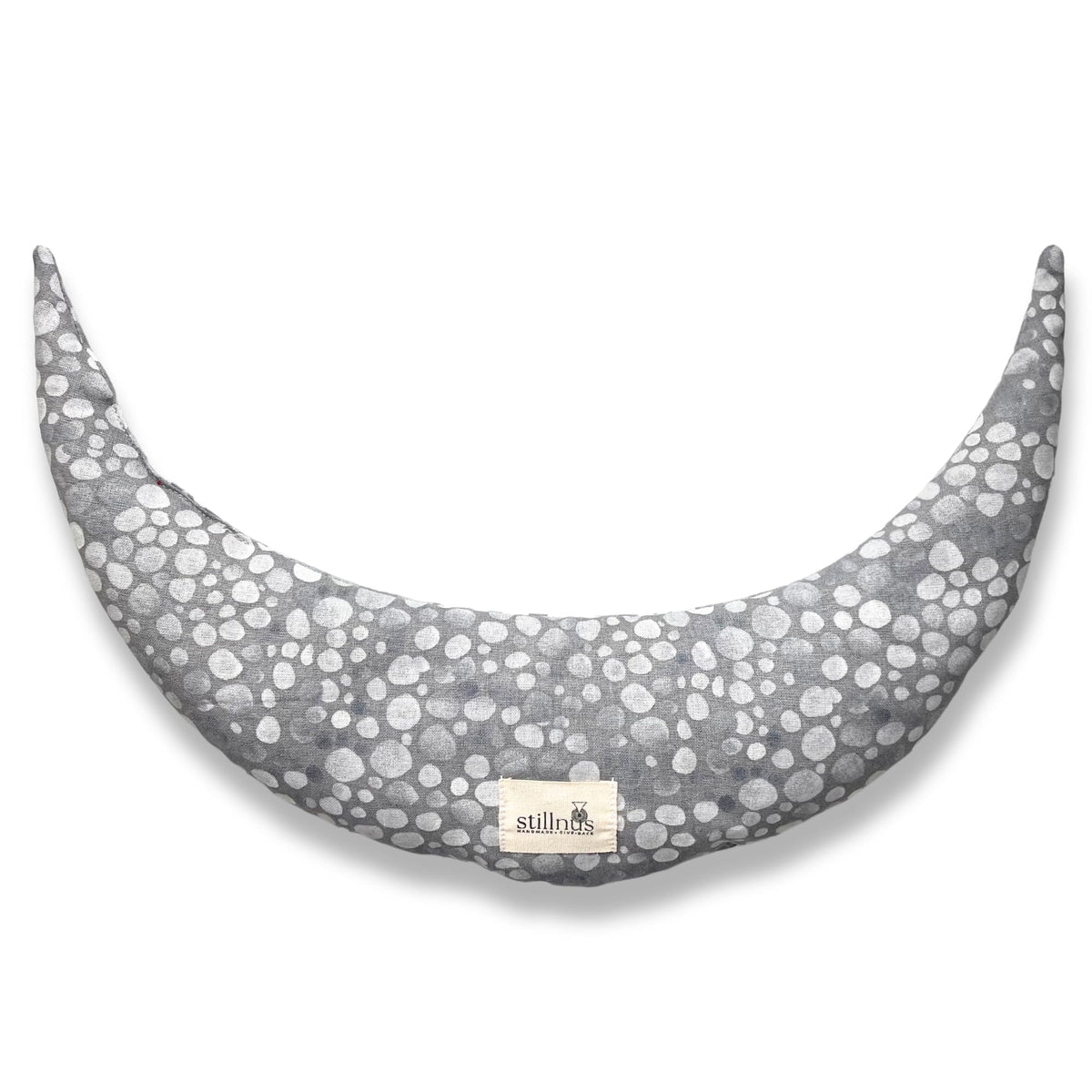 Stillnus Crescent Moon Pillow in grey dots offers neck support with lavender aromatherapy.