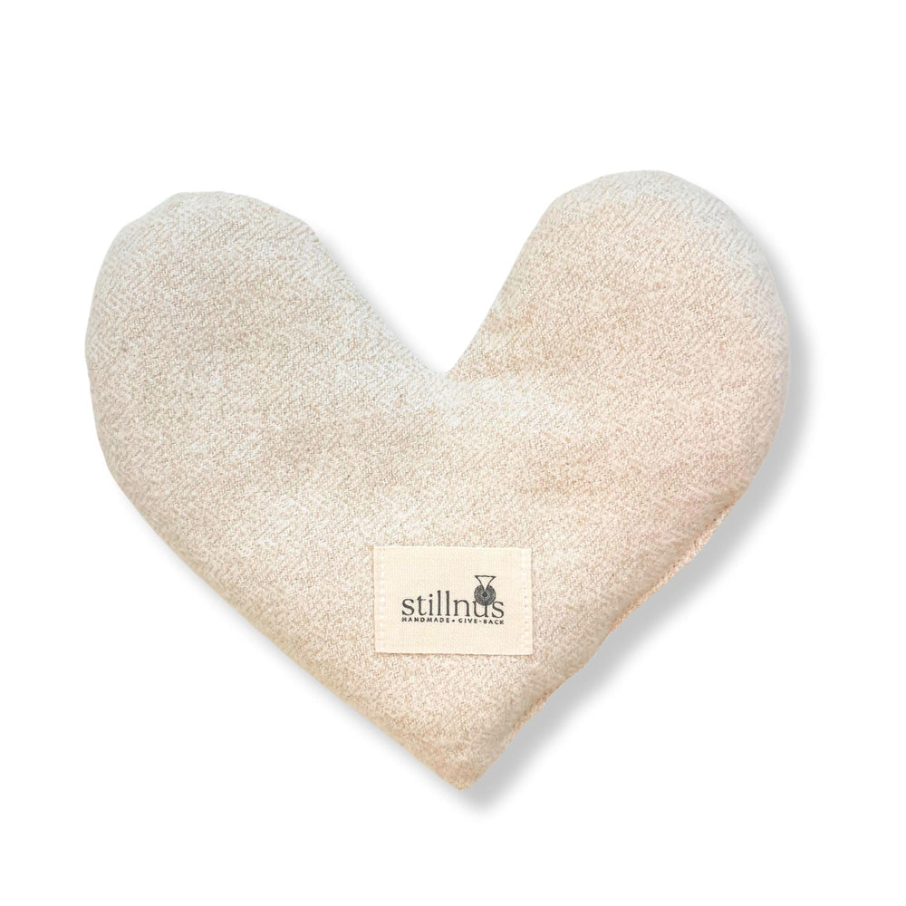 Stillnus weighted heart eye pillow closeup for calming pressure during relaxation.