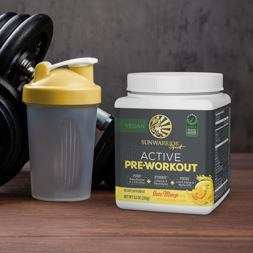 Sunwarrior Pre Workout glass with cold water ready for training session.