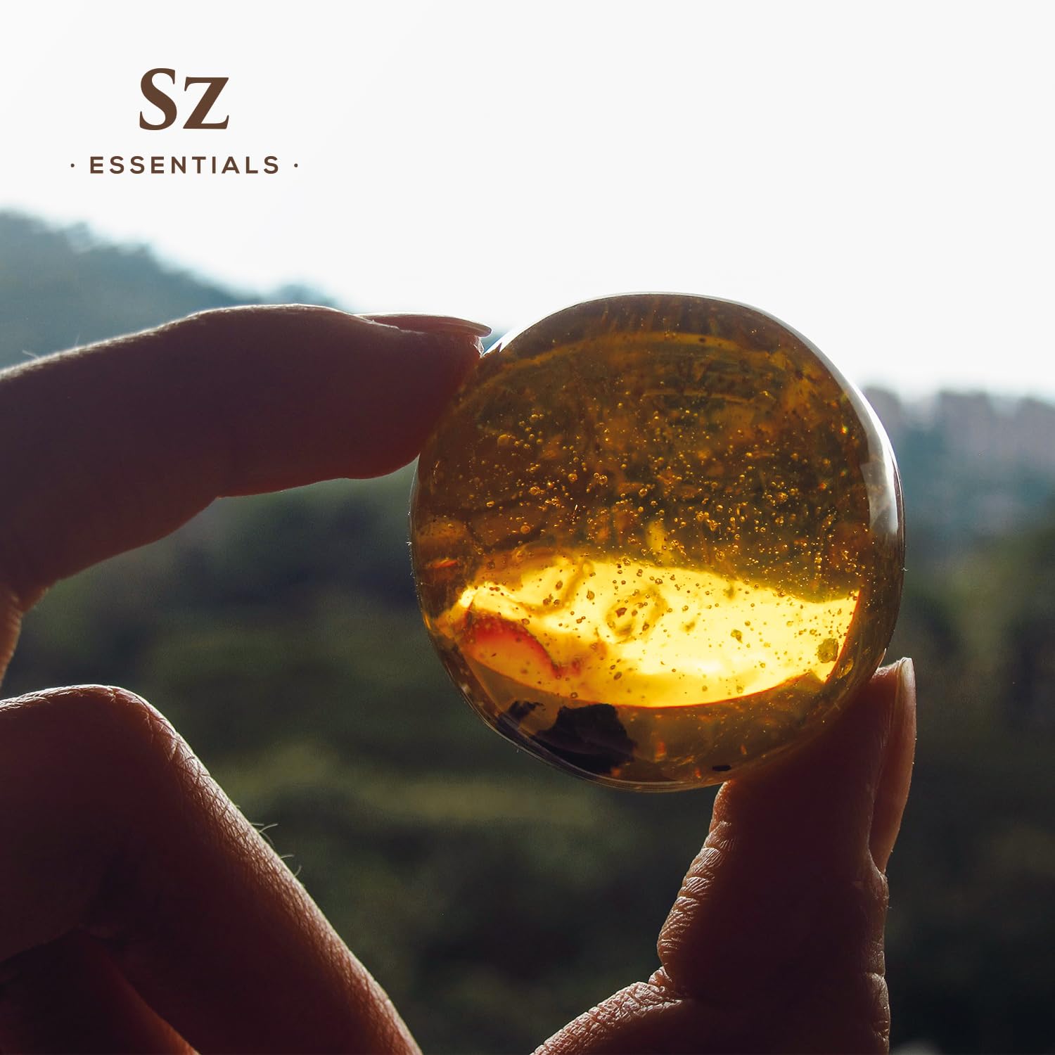 Sz Essentials Amber Oil in a calming self-care setup.