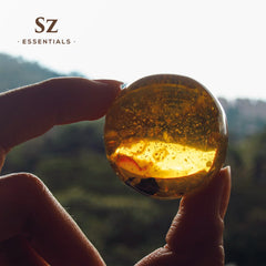 Sz Essentials Amber Oil in a calming self-care setup.