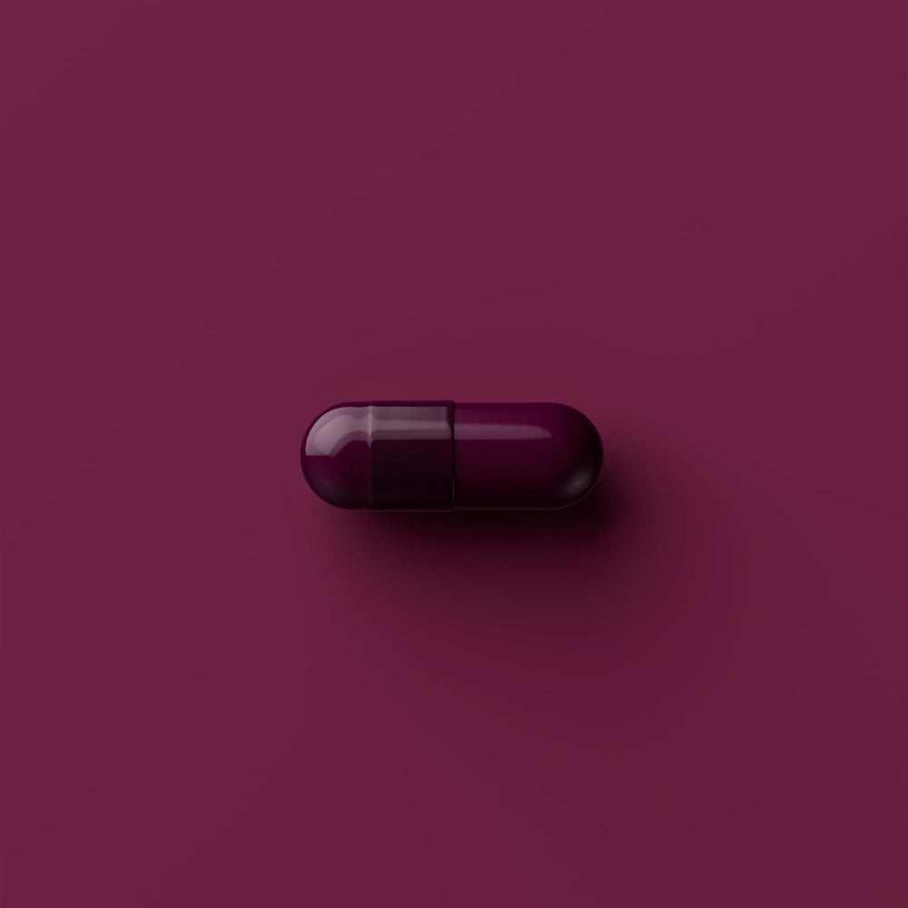 Tally Health capsules in hand illustrate simple dosing for daily wellness goals.