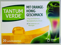 Tantum Verde orange-honey lozenges in hand for on-the-go use.