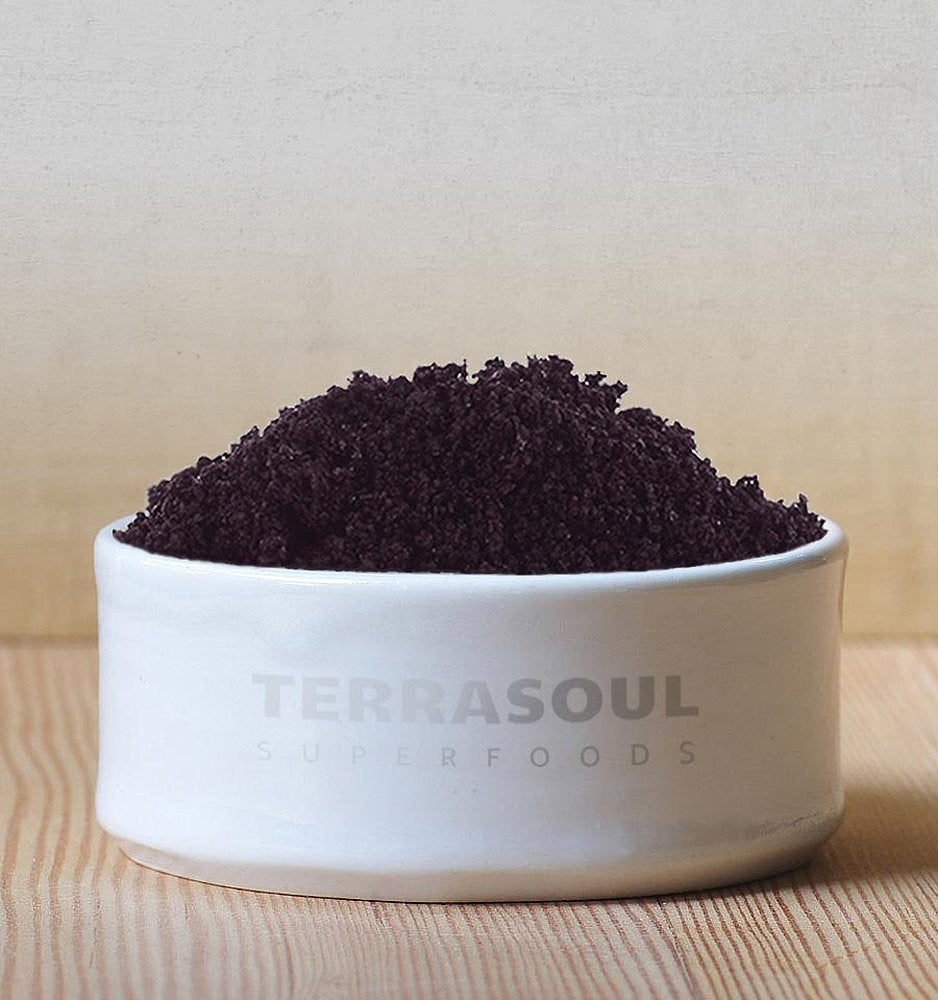 Terrasoul acai powder being scooped, easy yogurt addition.