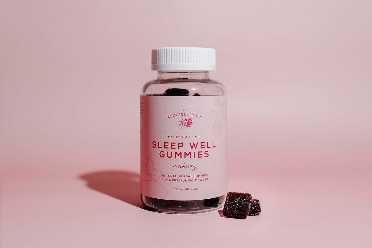 The Elderberry Co Sleep Well bottle on a nightstand promotes calm unwinding.