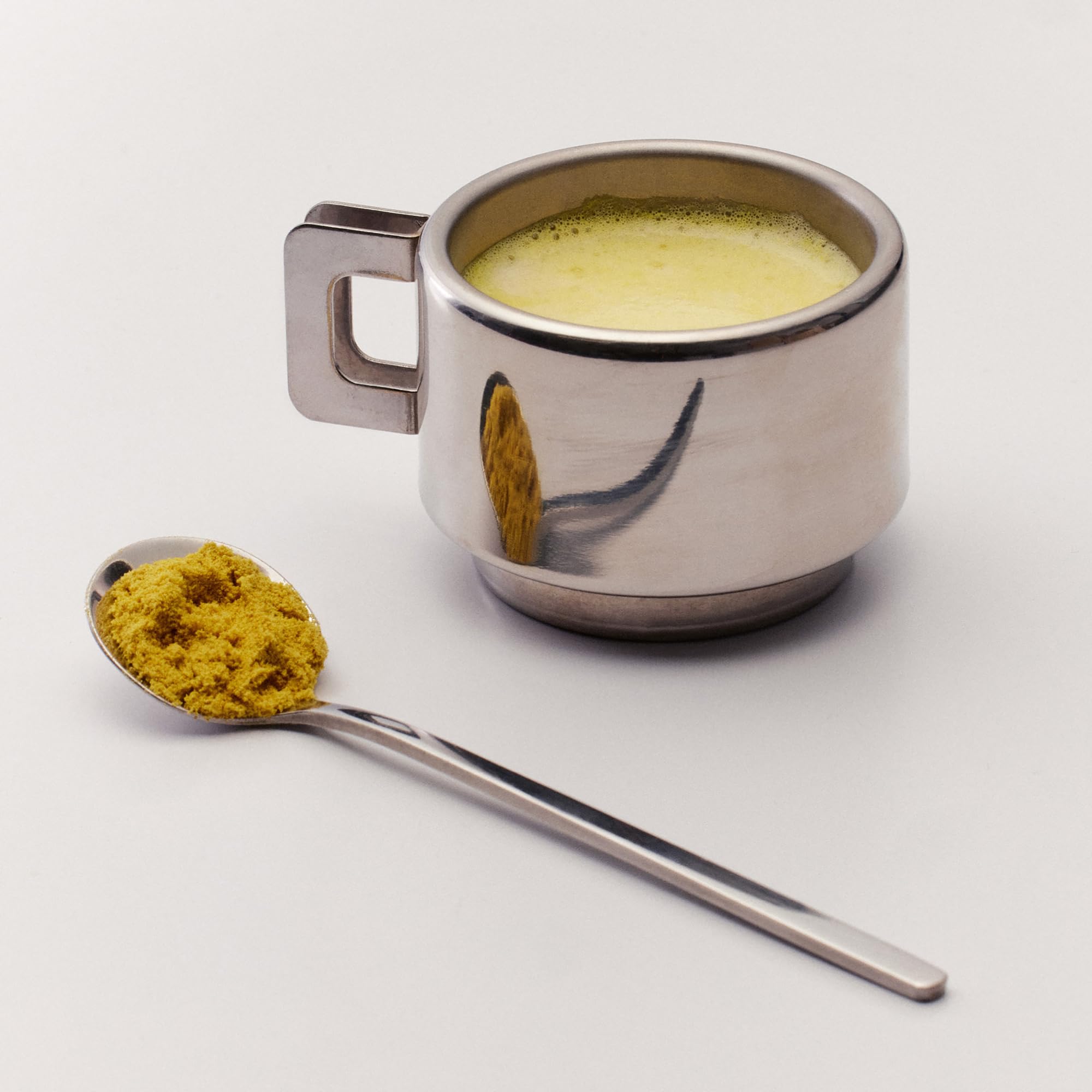 The Nue Co Debloat Gut Barrier+ powder dissolving smoothly in water.