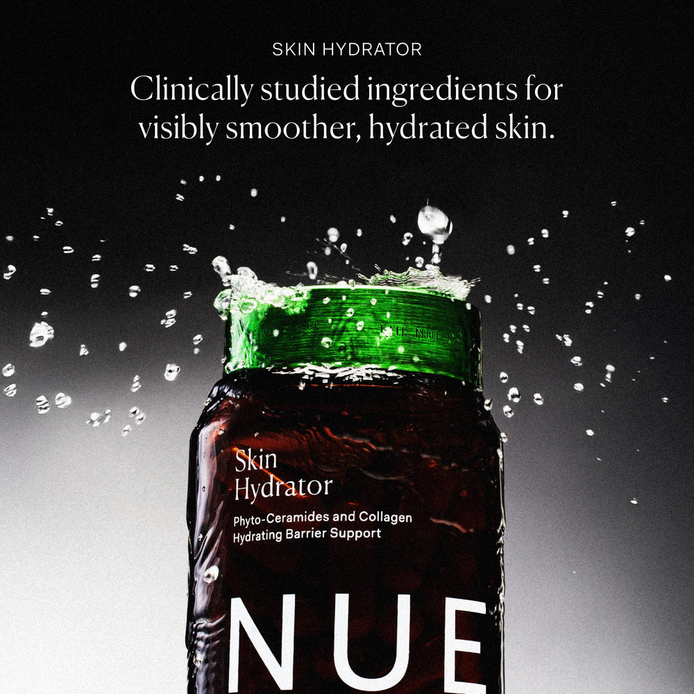 Glass bottle of The Nue Co Skin Hydrator on a bathroom shelf for daily use