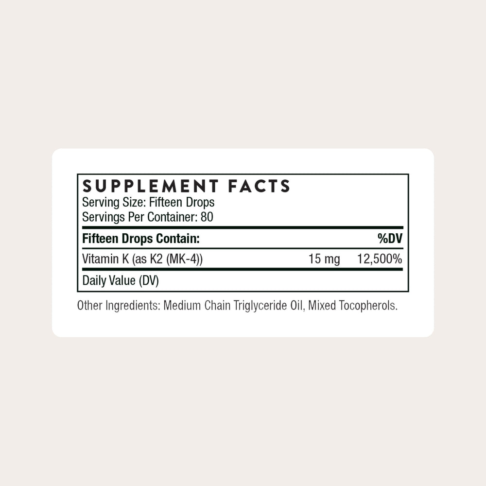 THORNE Vitamin K2 Liquid dropper dispensing a precise 1 mg drop for dosing accuracy.