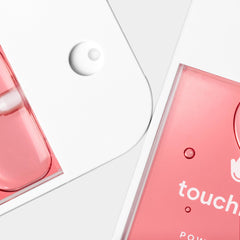 Hand applying Touchland sanitizer spray for on-the-go use