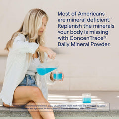 Pouring ConcenTrace powder into a glass for remineralization
