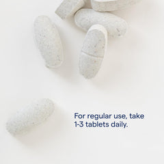 Trace Minerals ConcenTrace tablets displayed beside a glass bottle for wellness