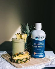 Trace Minerals Liquid Multi Vitamin-Mineral glass close-up showing vitamin color and label details for trust.