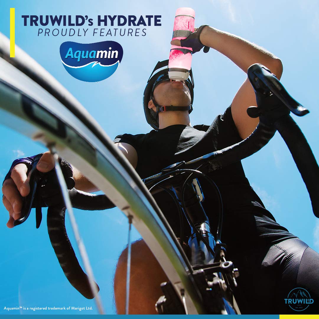 Glass of TruWild Hydrate prepared for outdoor activity hydration.
