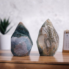 Tumbeelluwa Ocean Jasper flame tower highlights natural color variations on a windowsill for inspiration.