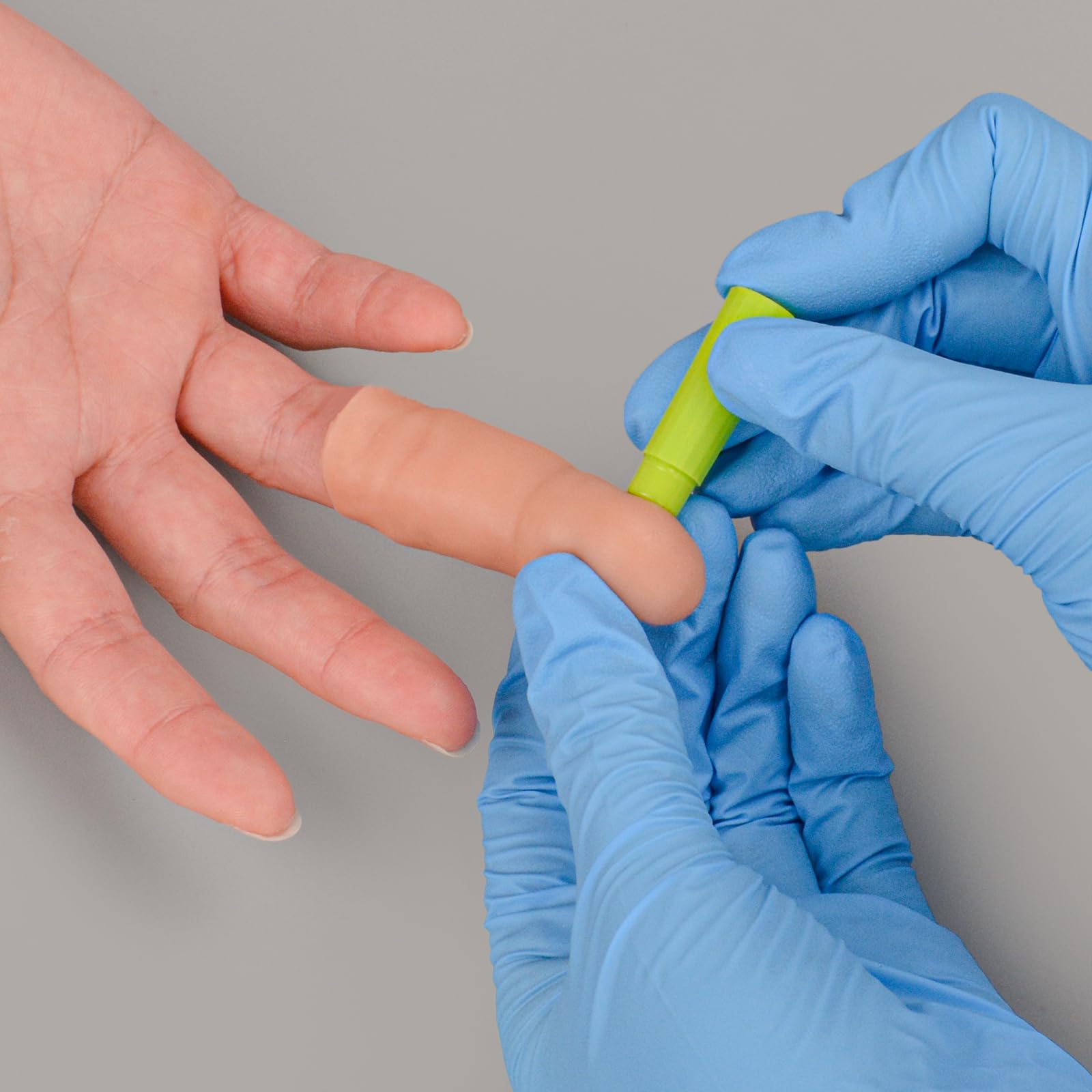 Ultrassist finger-stick trainer shows protective lining to prevent puncture