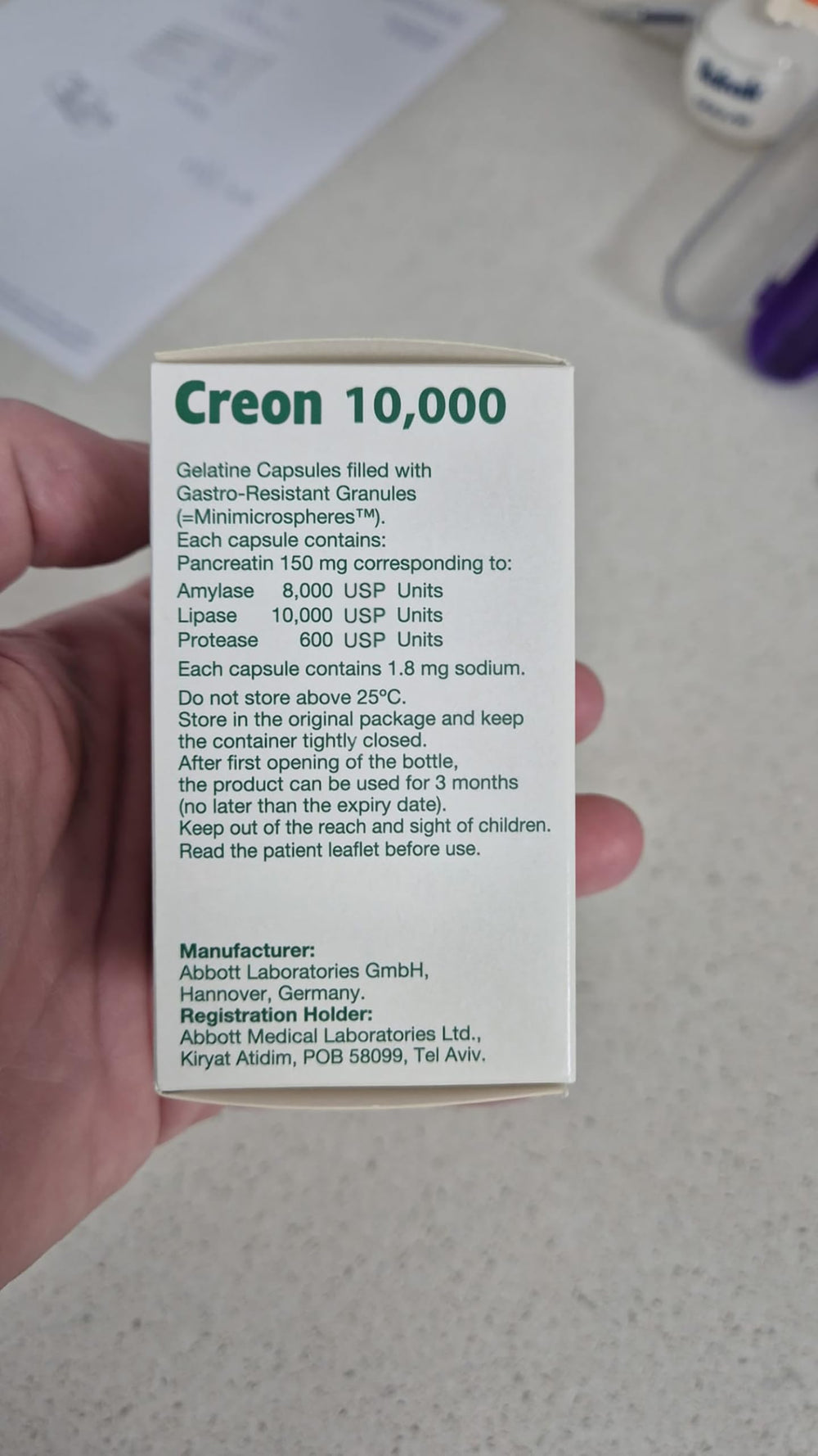 UPAX Creon 10,000 bottle shown beside a meal for daily use