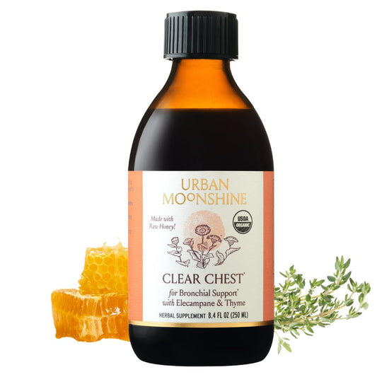 Urban Moonshine Clear Chest Syrup bottle on a wooden surface for respiratory support